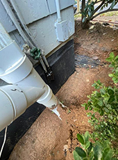 pipe outside a home going into dirt